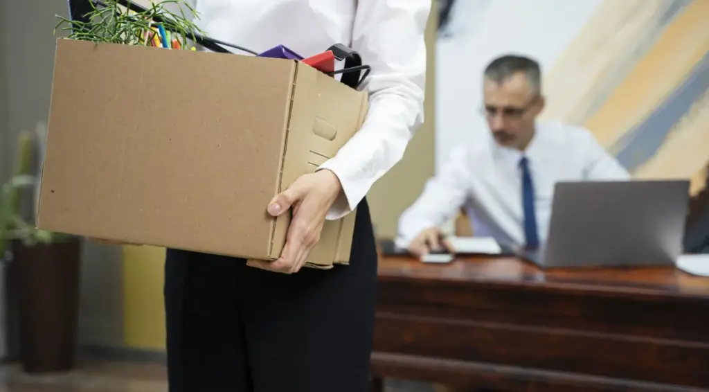 woman carrying cardboard box side view