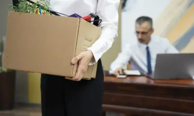 woman carrying cardboard box side view