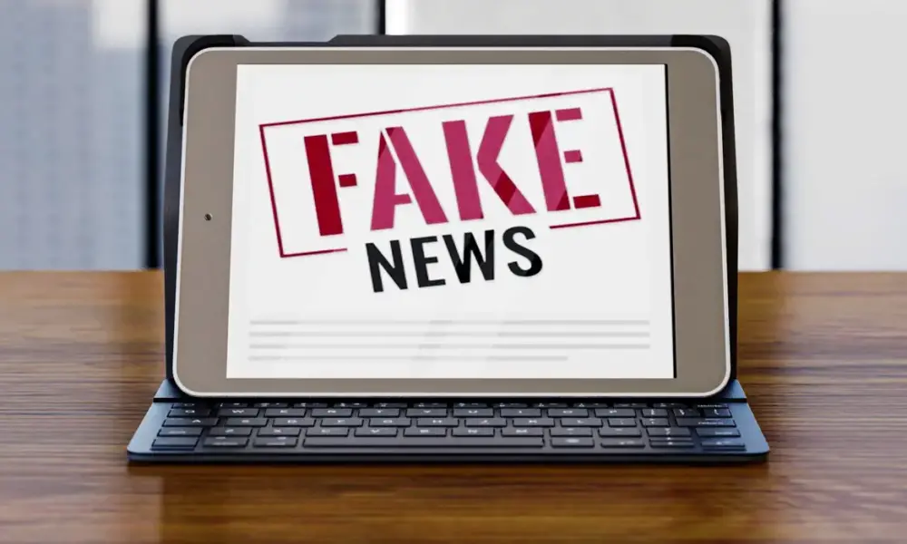 front view laptop desk with fake news 0