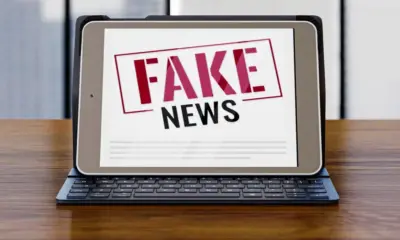 front view laptop desk with fake news 0